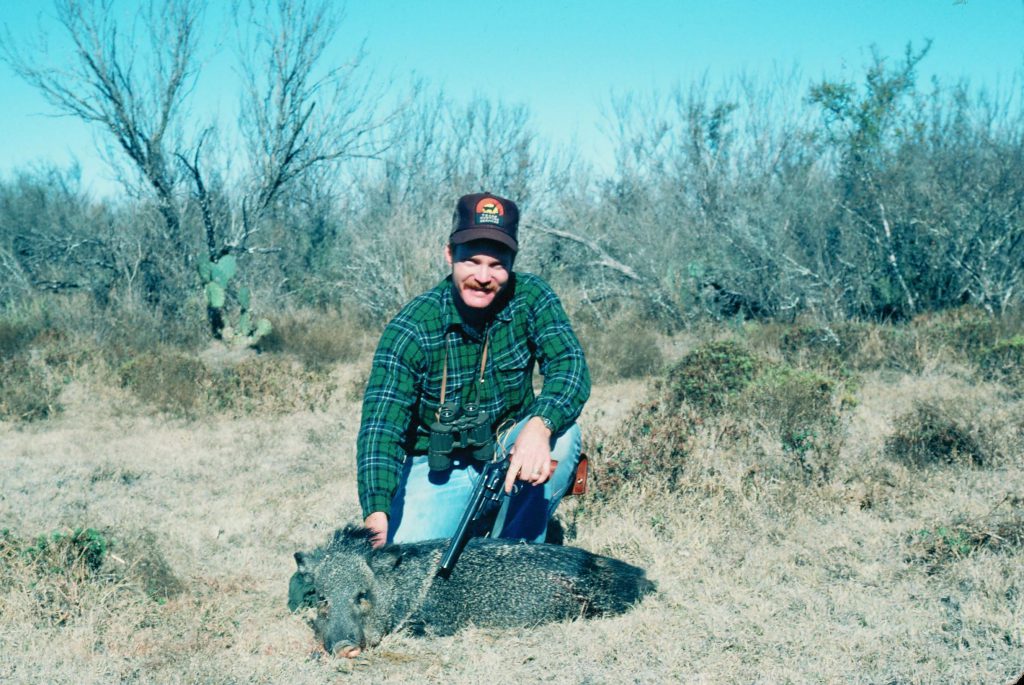 Javelina .44: A young Boddington with a javelina, taken with one of his most memorable shots with a handgun, a bit over 100 yards with an 8 3/8-inch barrel S&W M29. Today his older eyes would preclude attempting such a shot with a handgun…but no issues with a carbine!
