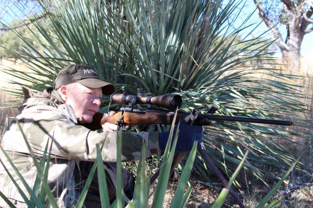 IMG_5756: Avoiding sharp-pointed yucca, Boddington used low shooting sticks to set up in a sitting position to take a Coues whitetail in northern Mexico. In his experience, the little Coues whitetail consistently offers some of the most difficult shooting in North American deer hunting.